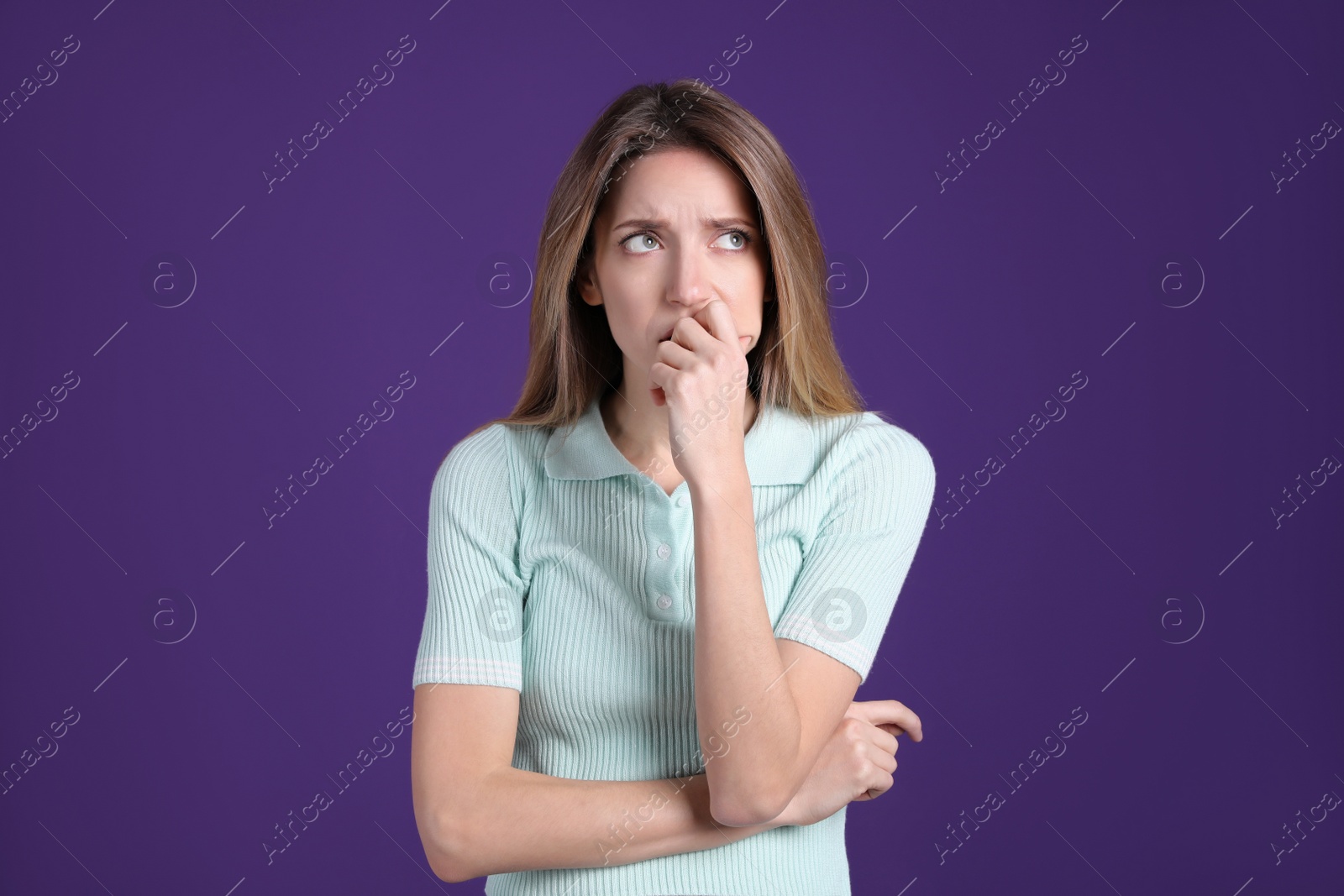 Photo of Portrait of stressed young woman on purple background