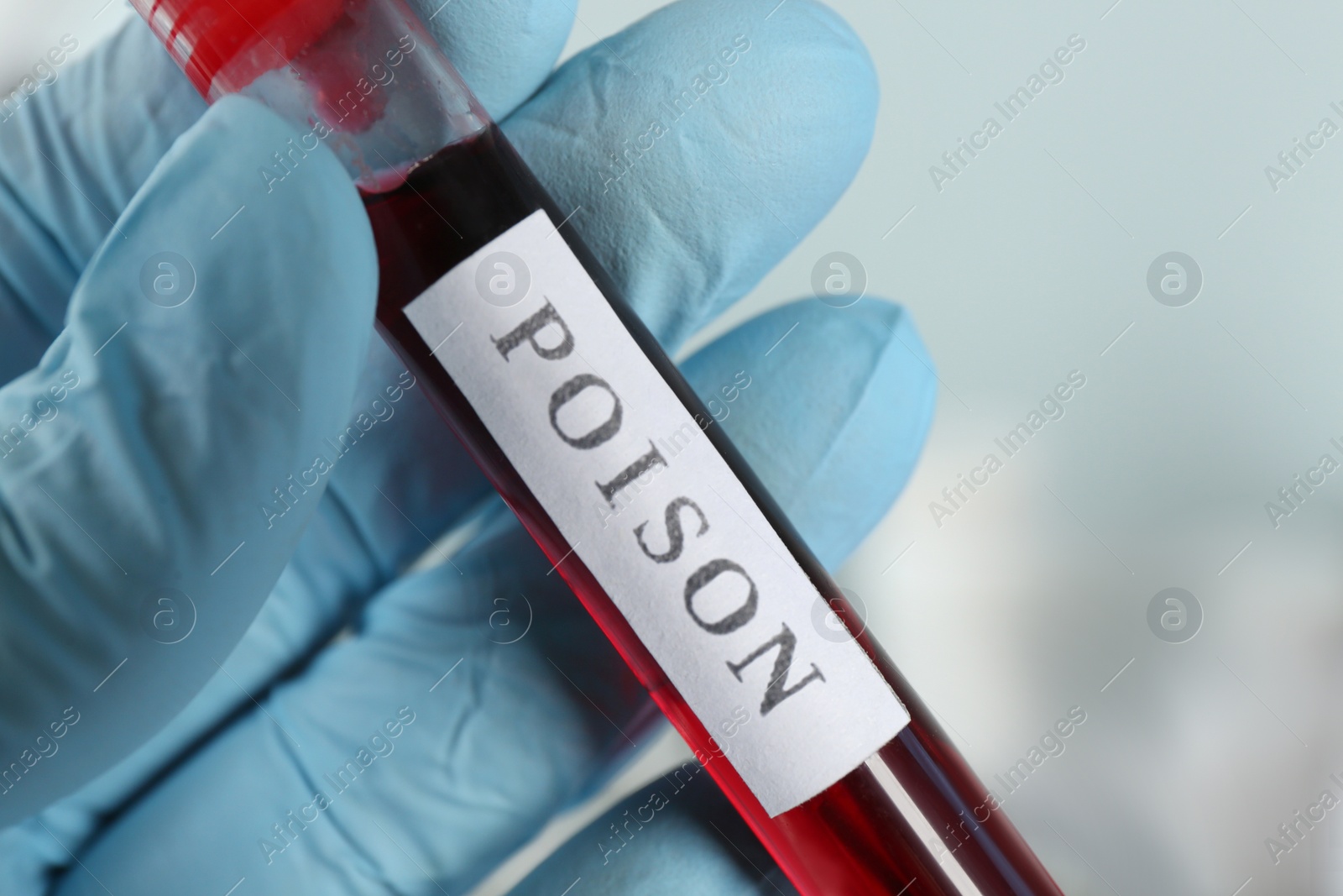 Image of Scientist holding test tube with poison, closeup