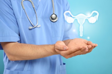 Doctor and illustration of female reproductive system on light blue background, closeup