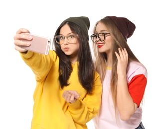 Attractive young women taking selfie on white background