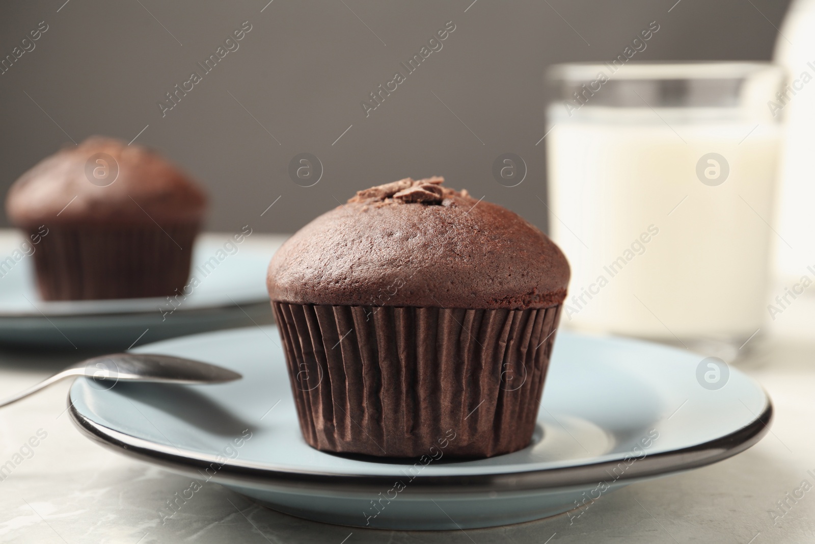 Photo of Delicious cupcake with chocolate crumbles on grey table, closeup