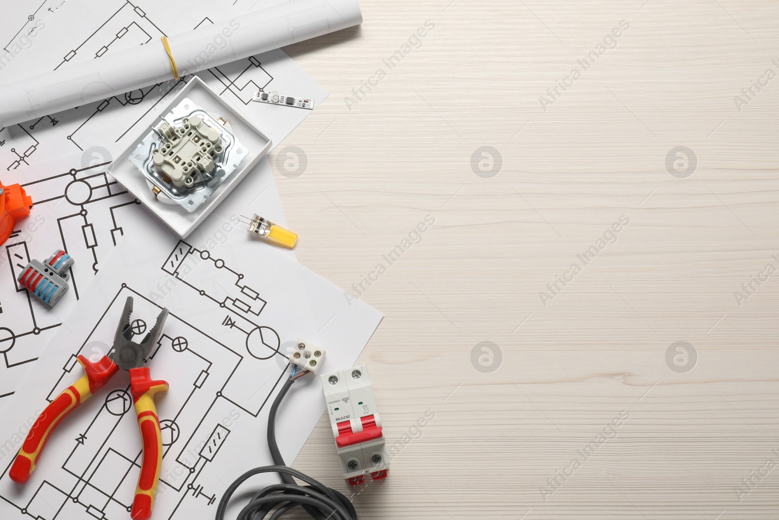 Photo of Flat lay composition with wiring diagrams on white wooden table, space for text