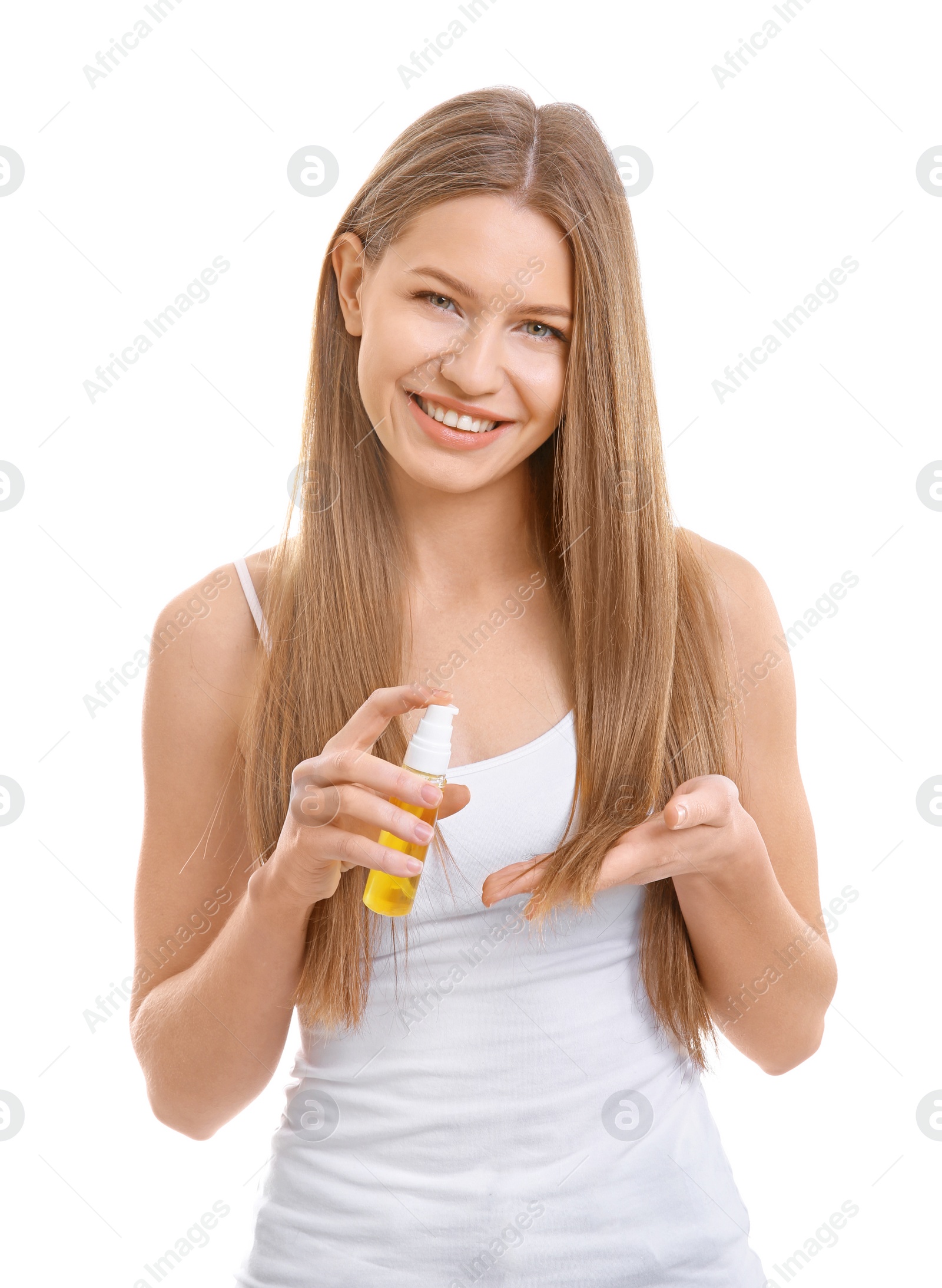 Photo of Young woman applying oil onto hair on white background