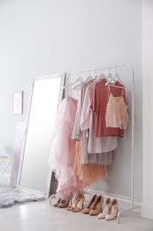 Modern dressing room interior with clothing rack and mirror