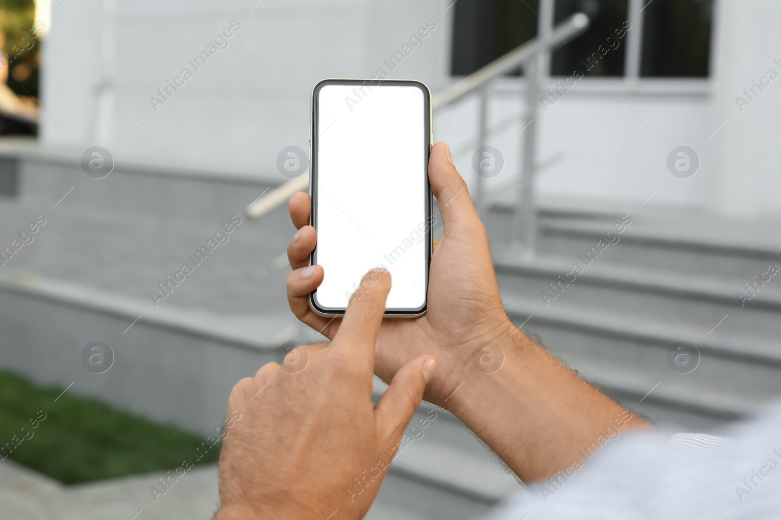 Photo of Man using modern mobile phone outdoors, closeup