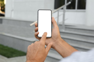 Man using modern mobile phone outdoors, closeup