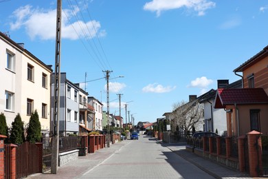 Photo of Suburban street with beautiful buildings on sunny spring day