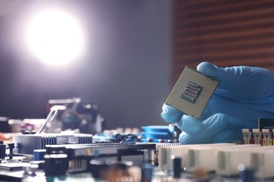 Photo of Technician repairing computer motherboard, closeup. Electronic device