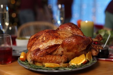 Photo of Festive dinner with delicious baked turkey served on table indoors, closeup. Christmas celebration