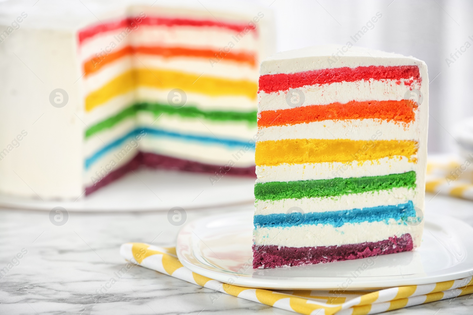 Photo of Delicious rainbow cake for party on table