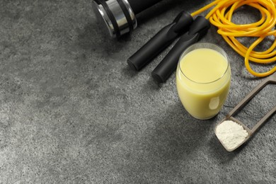 Photo of Tasty shake, sports equipment and powder on stone table, above view with space for text. Weight loss