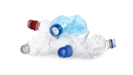 Photo of Pile of crumpled bottles isolated on white. Plastic recycling