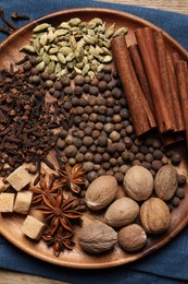 Photo of Different spices and nuts on table, top view