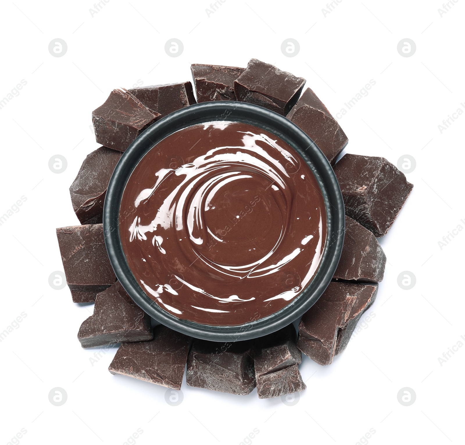 Photo of Tasty milk chocolate paste in bowl and pieces isolated on white, top view