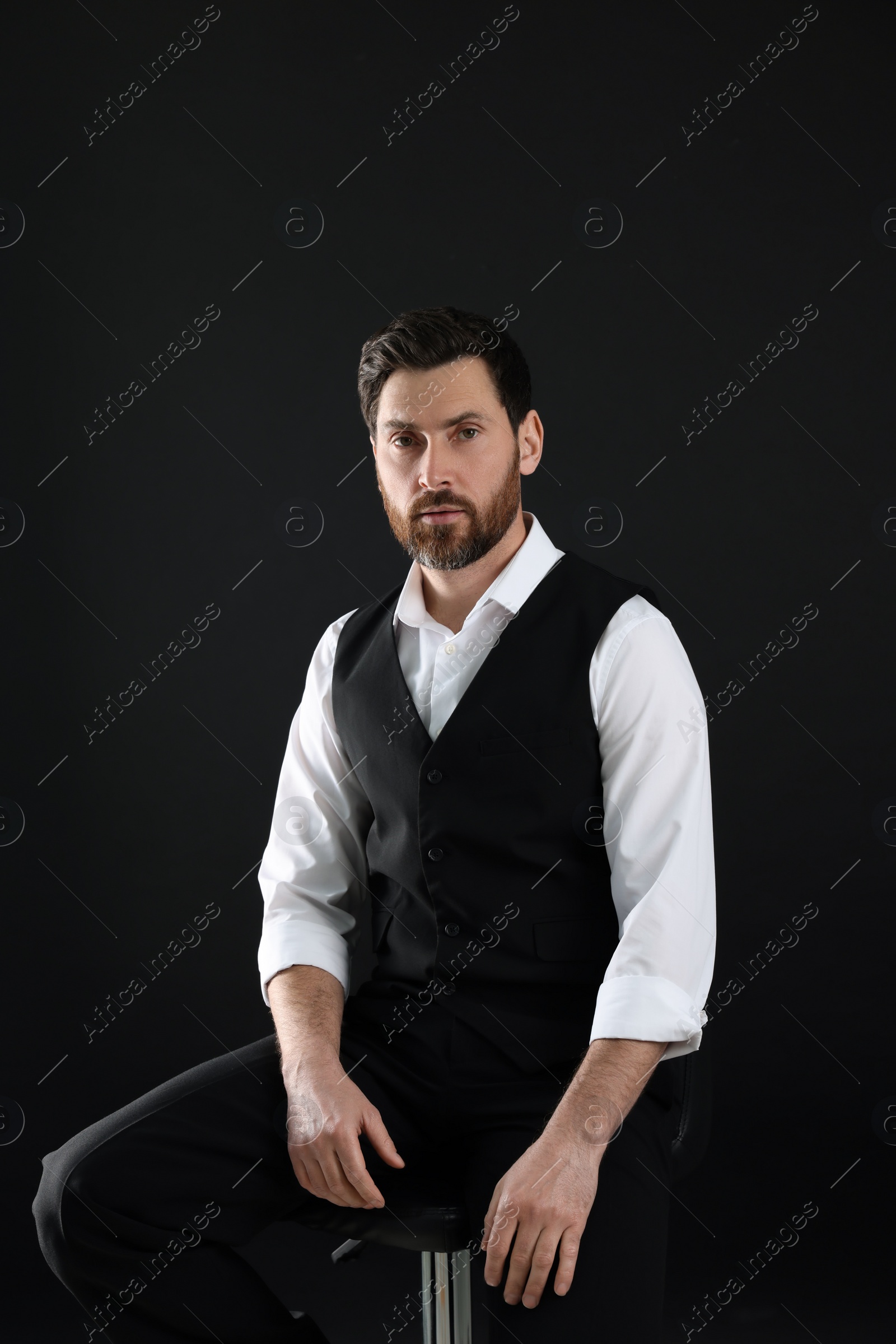 Photo of Portrait of handsome bearded man on black background