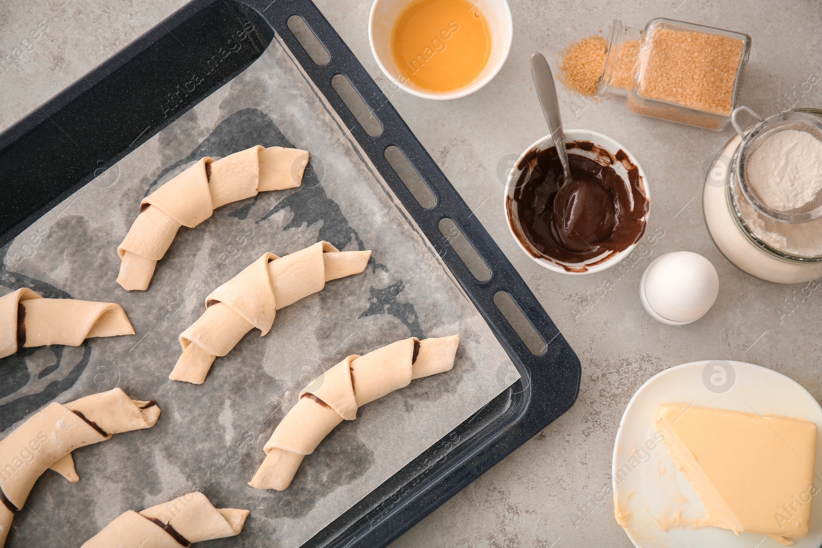 Photo of Flat lay composition with ingredients and raw croissants on grey background