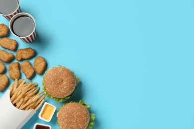 Photo of Flat lay composition with delicious fast food menu on light blue background. Space for text