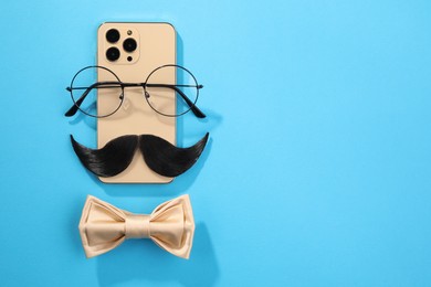 Photo of Flat lay composition with artificial moustache and glasses on light blue background, space for text