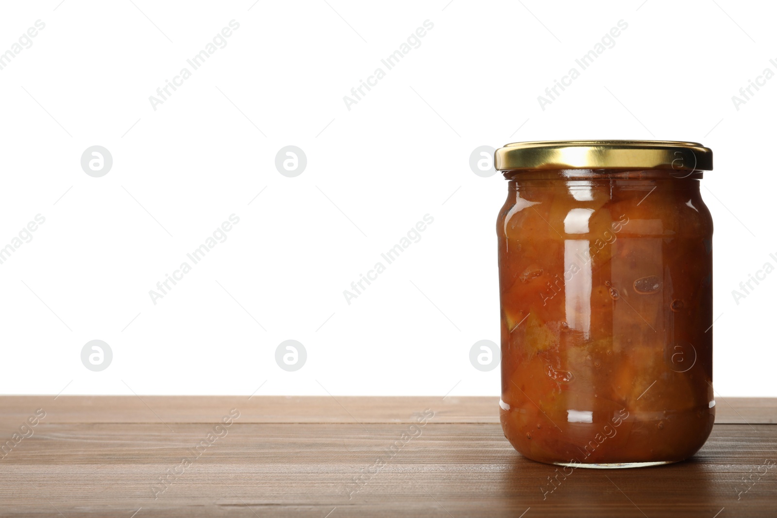 Photo of Glass jar with apple jam on wooden table against white background, space for text