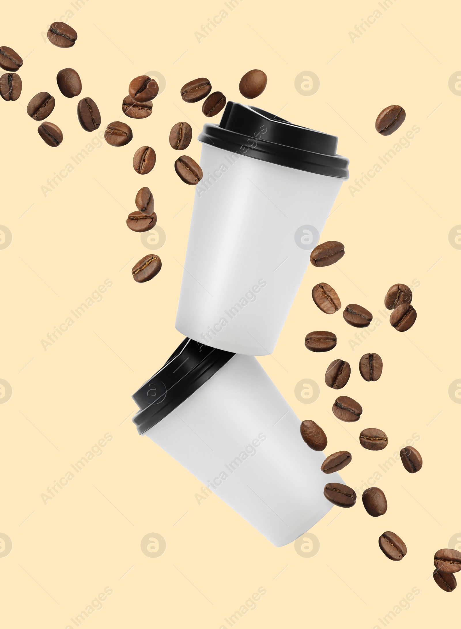 Image of Coffee to go. Paper cups and roasted beans flying on beige background