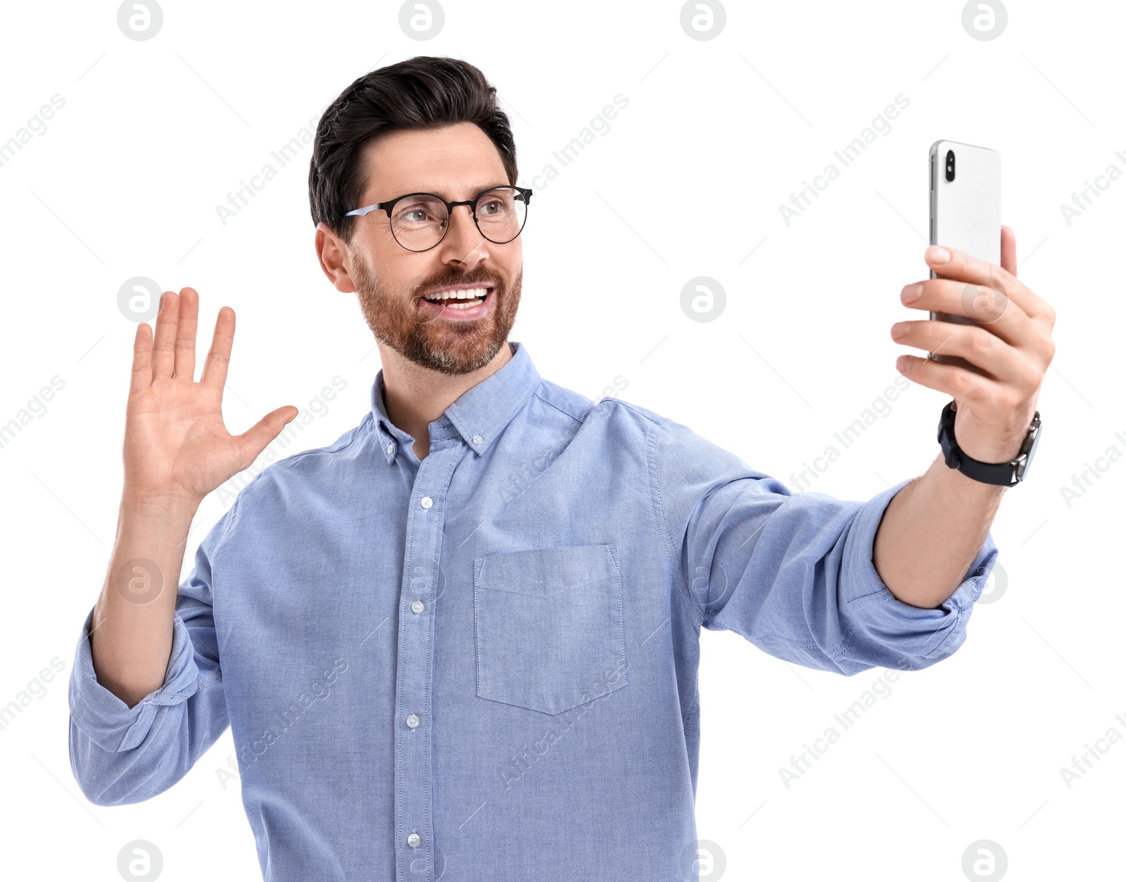 Photo of Smiling man taking selfie with smartphone on white background