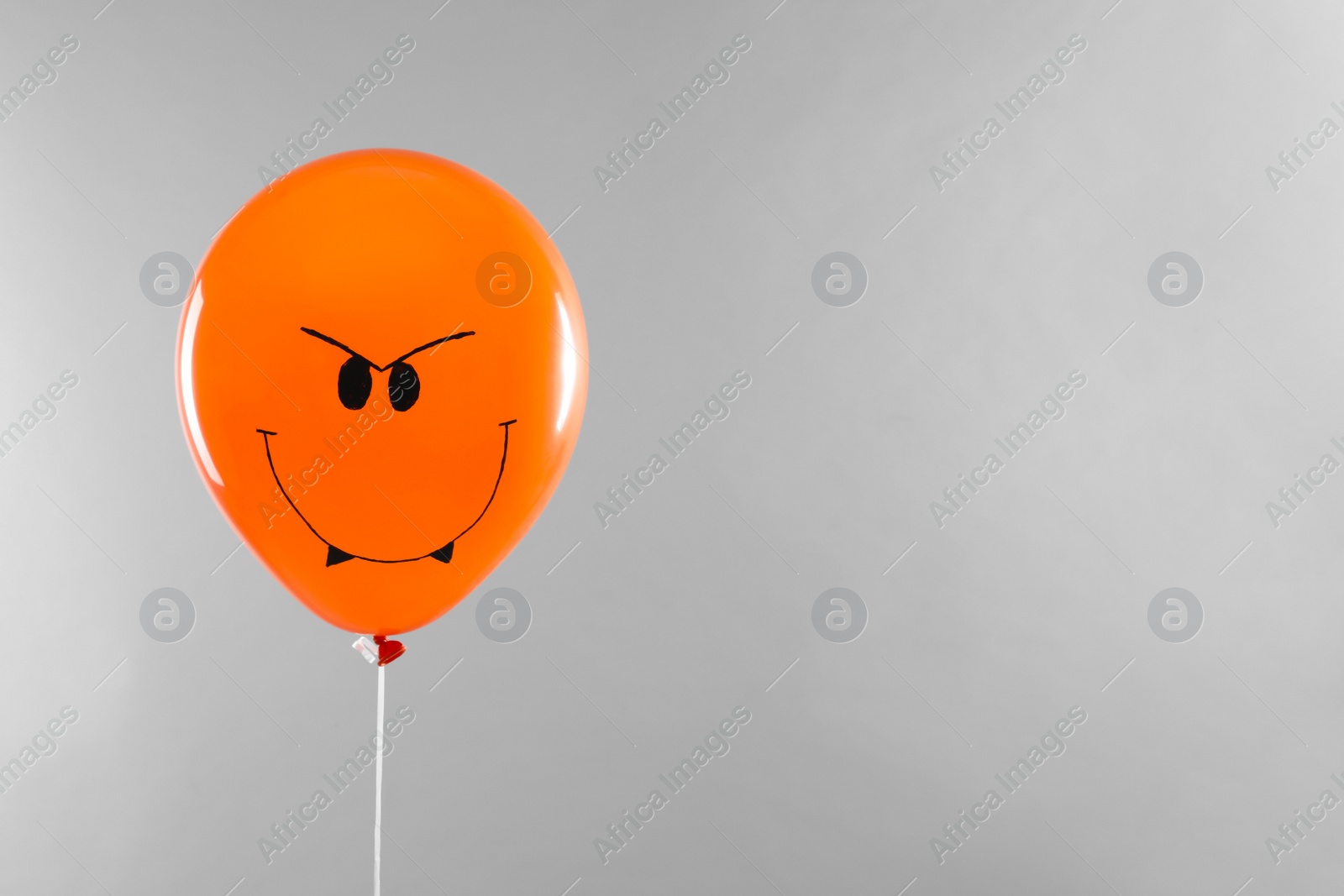 Photo of Spooky balloon for Halloween party on light grey background, space for text