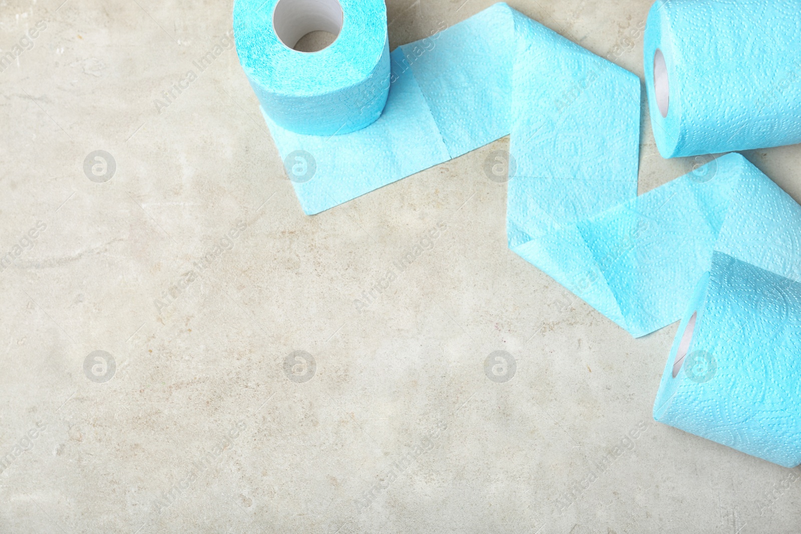 Photo of Toilet paper rolls on grey background, top view. Space for text