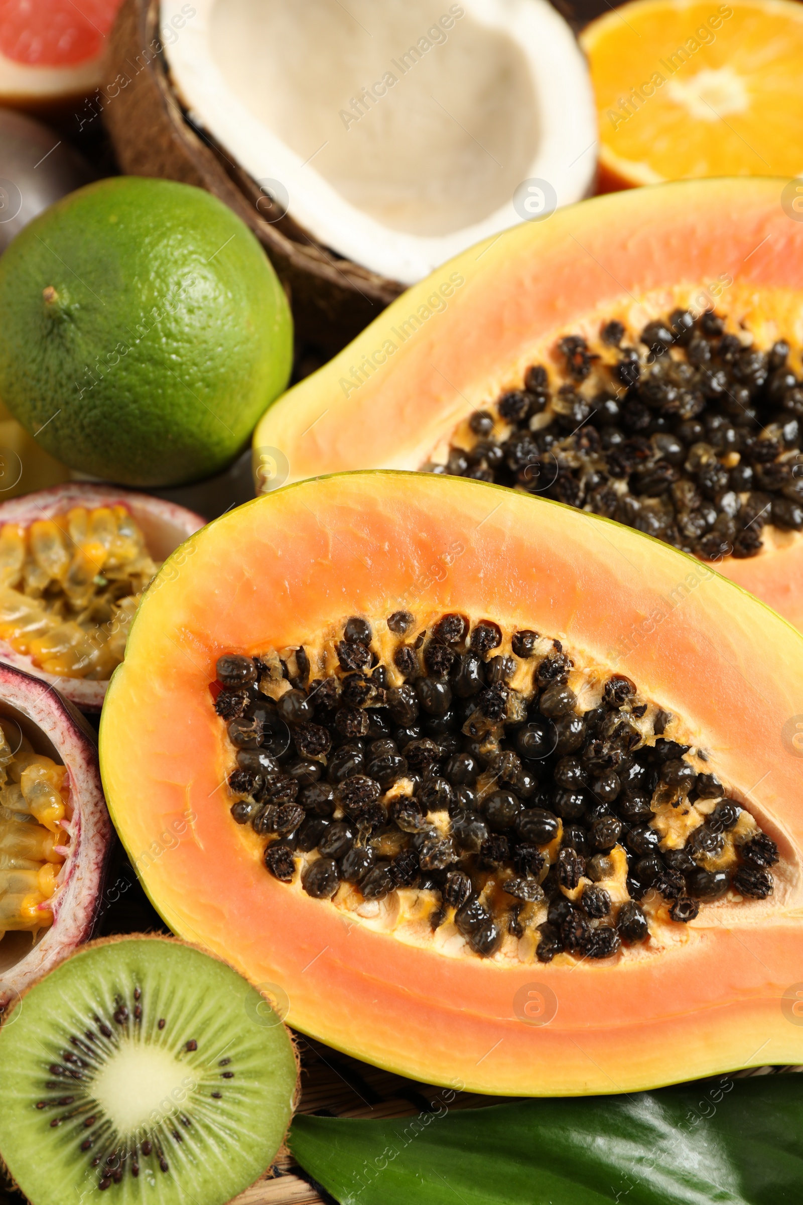 Photo of Fresh ripe papaya and other fruits as background, closeup