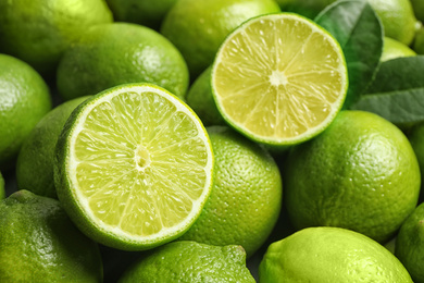 Photo of Fresh ripe juicy limes as background, closeup