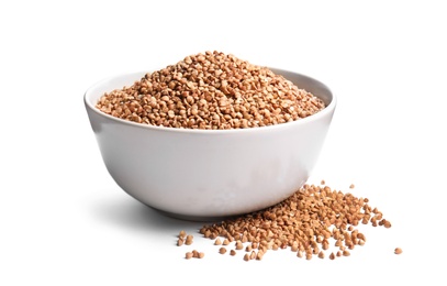 Bowl with uncooked buckwheat on white background