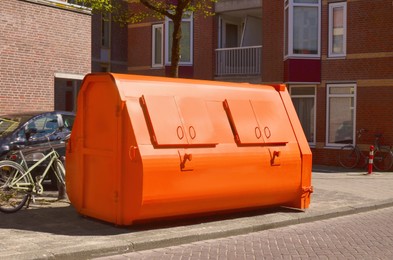 Portable orange metal container on city street