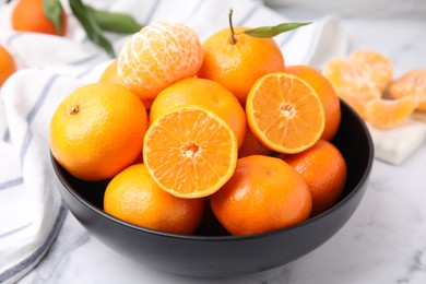 Photo of Fresh juicy tangerines on white marble table, , closeup