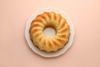 Photo of One tasty sponge cake on beige background, top view