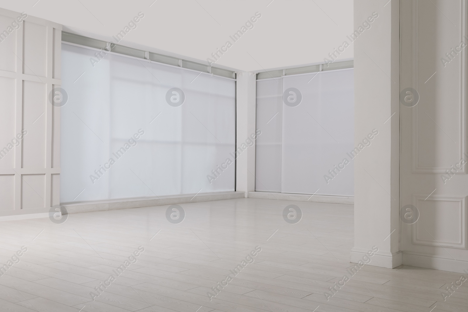 Photo of Empty room with beige walls and laminated flooring