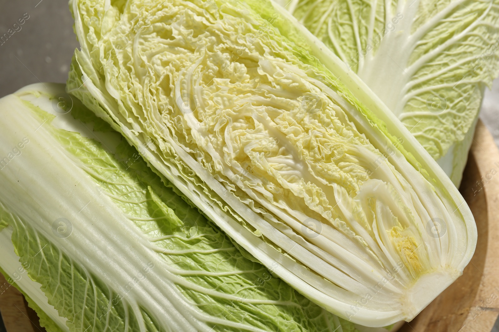 Photo of Fresh ripe Chinese cabbages in bowl on table, top view