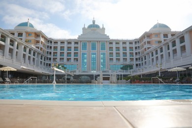 Beautiful view of hotel with swimming pool at resort