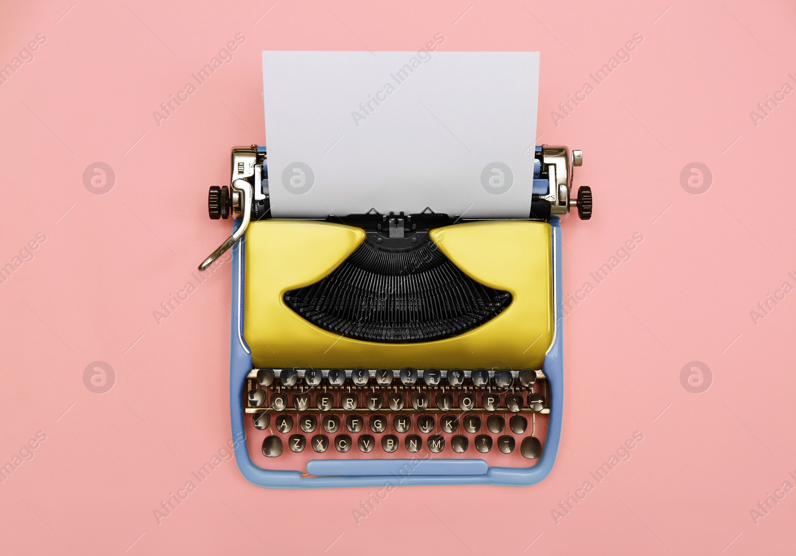 Image of Copywriter. Vintage typewriter on pink background, top view