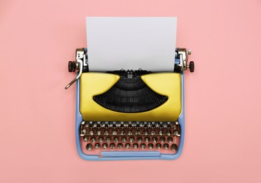 Image of Copywriter. Vintage typewriter on pink background, top view