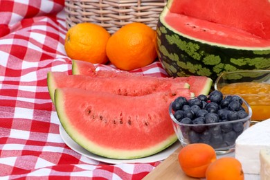 Picnic blanket with delicious food, closeup view