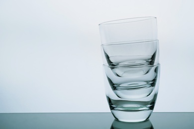 Photo of Stack of empty whiskey glasses on white background