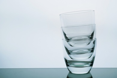 Stack of empty whiskey glasses on white background