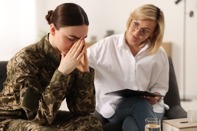 Photo of Psychotherapist working with military woman in office