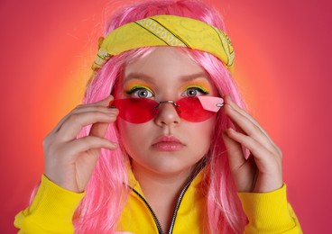 Cute indie girl with sunglasses on bright pink background