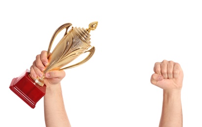 Young man holding gold trophy cup on white background, closeup