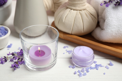 Photo of Cosmetic products and lavender flowers on white wooden table