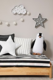 Comfortable floor bed with pillows and toy indoors. Cute kids room interior