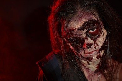 Photo of Scary zombie on dark background, closeup. Halloween monster