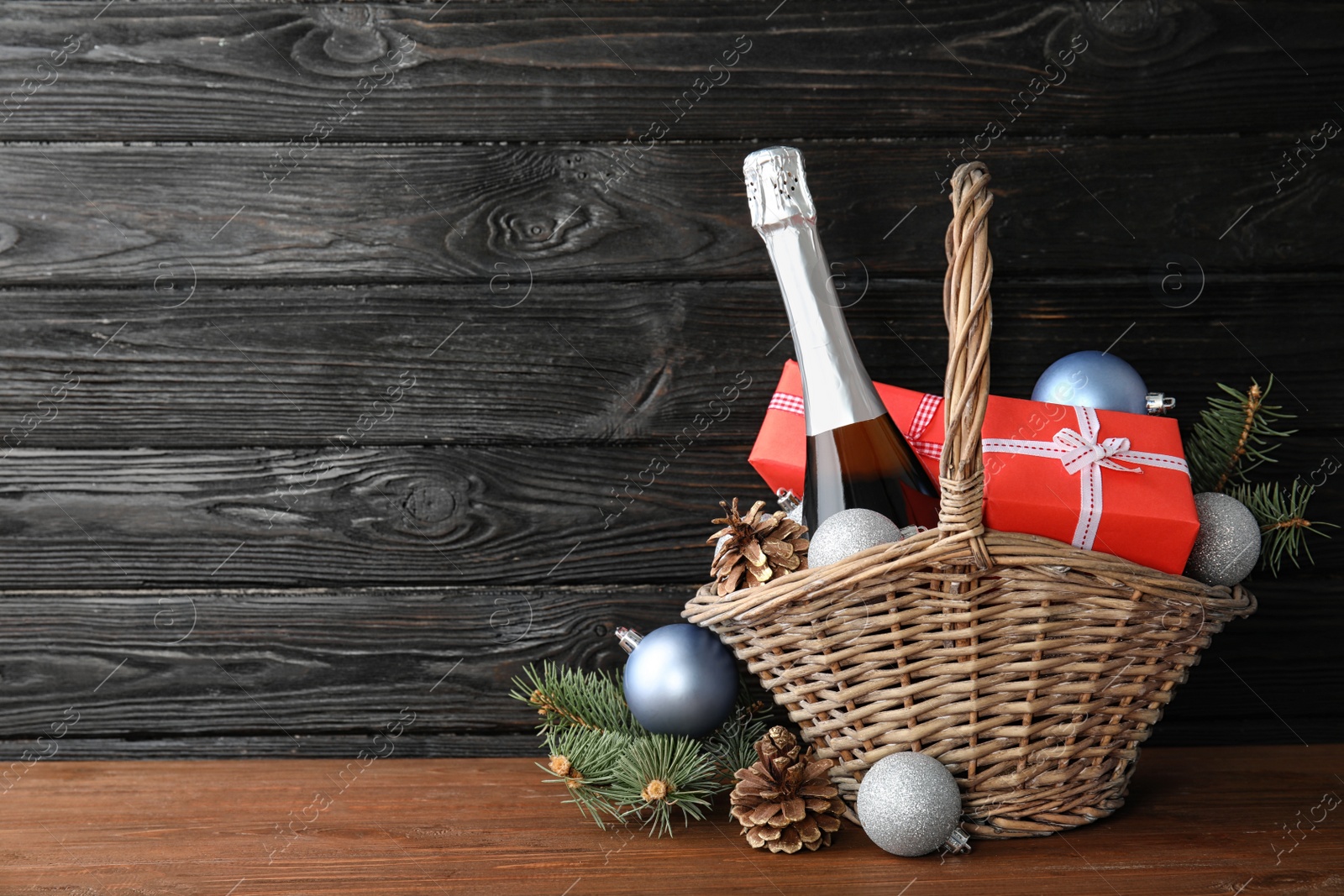 Photo of New year composition with champagne and space for text on wooden background