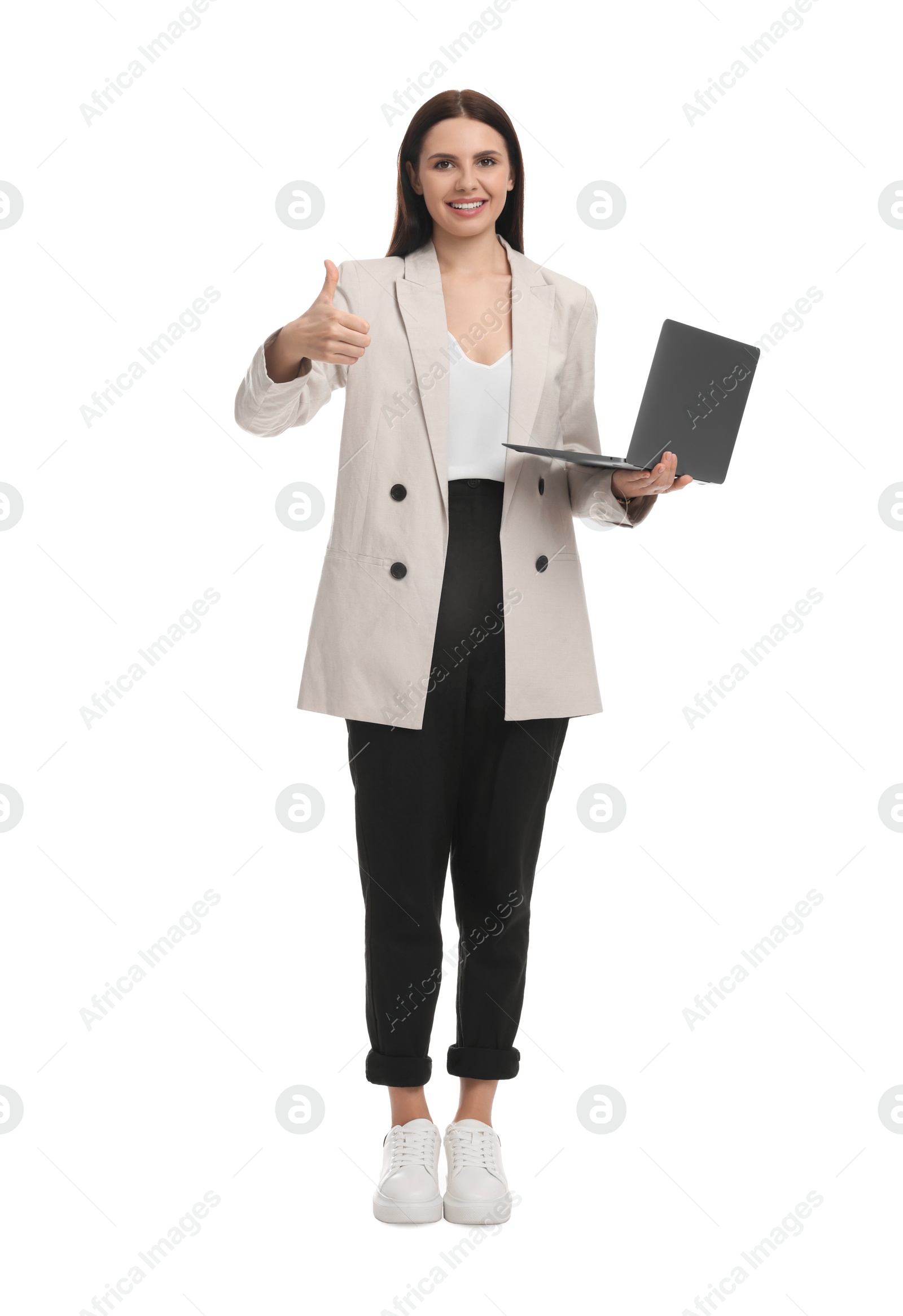 Photo of Beautiful businesswoman in suit with laptop showing thumbs up on white background