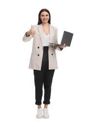 Beautiful businesswoman in suit with laptop showing thumbs up on white background